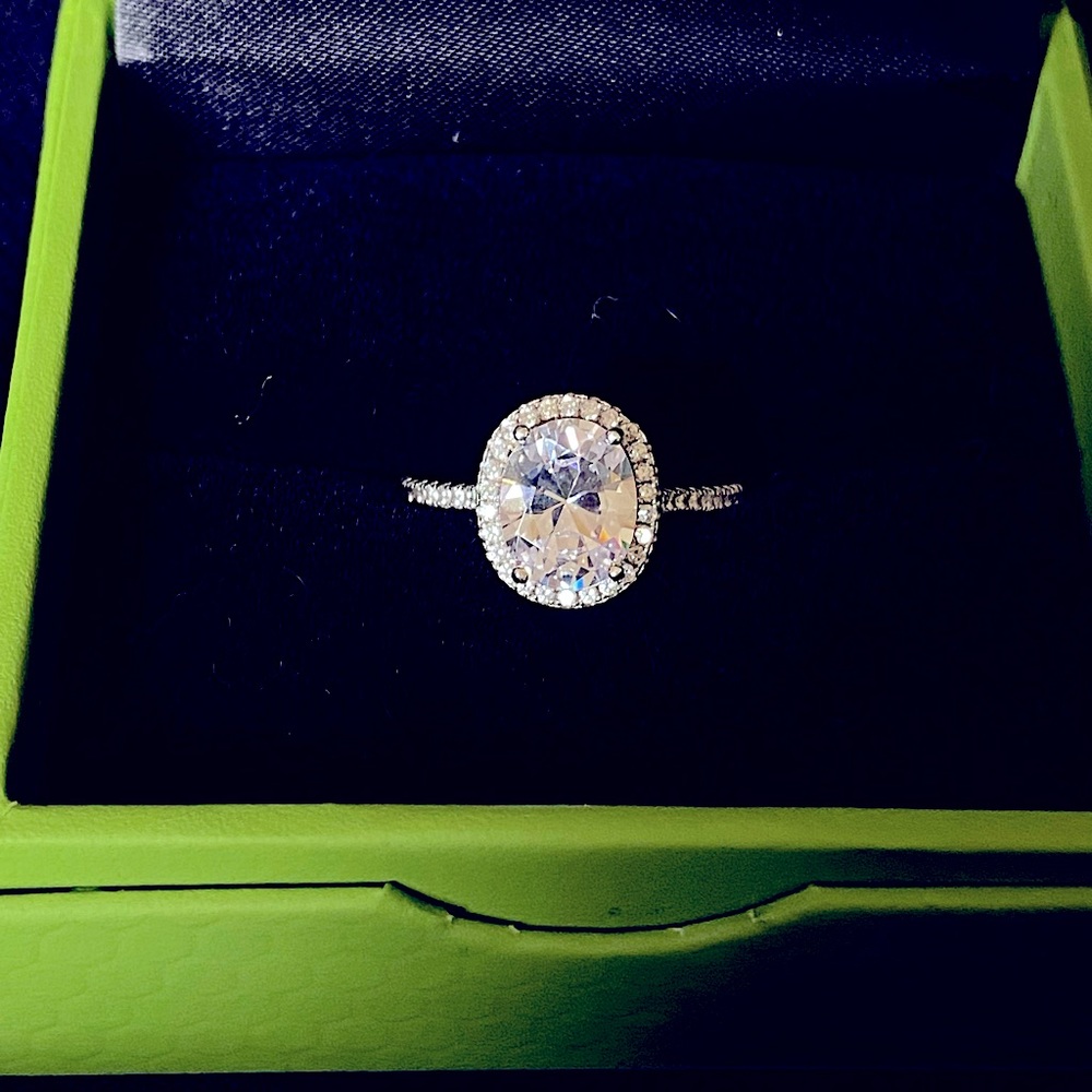 Simulated oval diamond ring with halo.